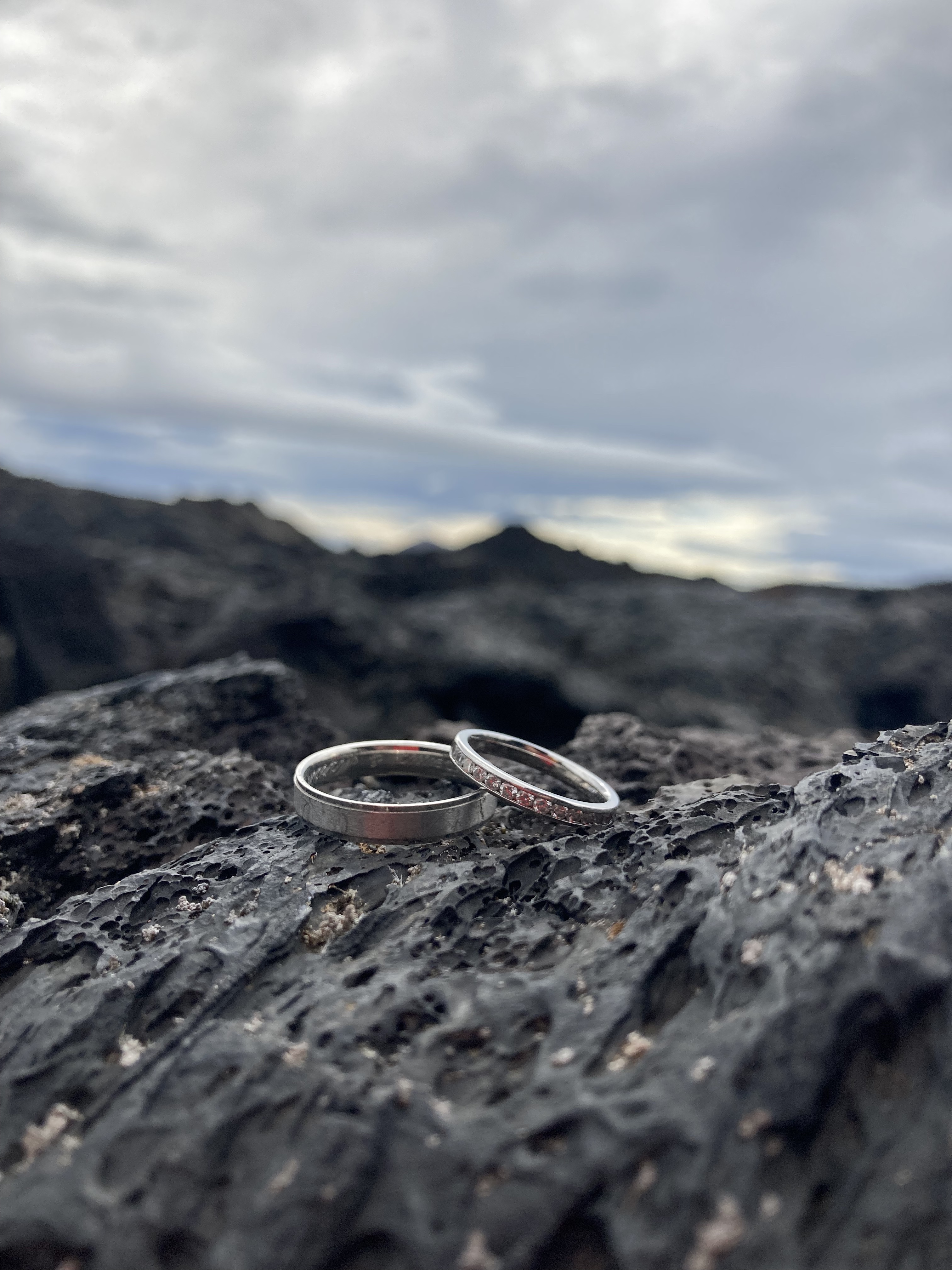 Two rings on a rock in Iceland showing a black mountain in the background